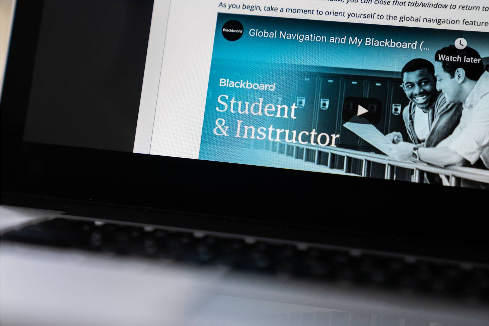 Close-up of a laptop screen showing a Blackboard Student & Instructor video thumbnail.